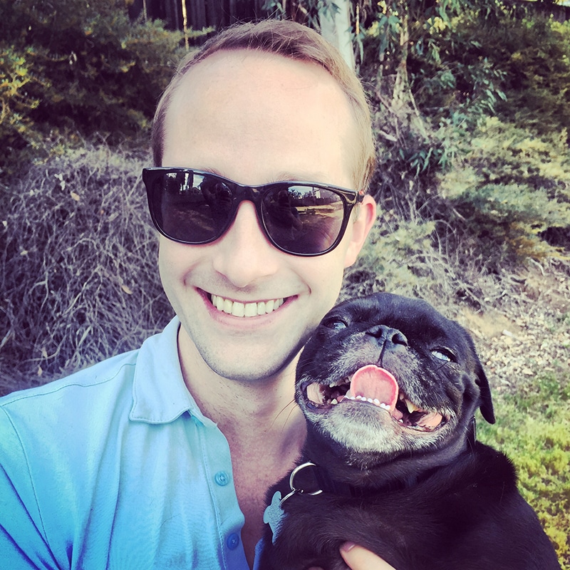 A cute pug and her human dad are smiling to the camera after they both ate a delicious and healthy meal